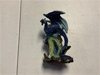 Dragon sitting on gem decorative piece