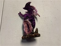 Dragon sitting on gem decorative piece