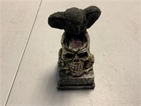 Black bird sitting on skull decorative piece