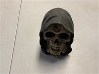 Skull in cloak sculpture