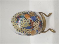 Decorative peacock egg with sand