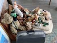 collection of teddy bears and traveling case