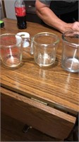 One Pyrex measuring cup and two others