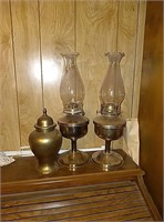 2 metal kerosene lantern and a brass vase