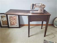 White electric sewing machine with cabinet