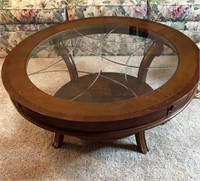 Glass topped wooden coffee table 40” diameter