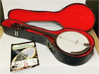 Four string banjo and case.