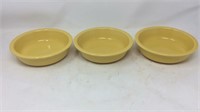Three yellow Fiesta bowls