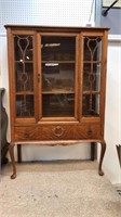 Antique oak china cabinet has a little trim