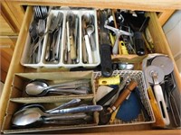 Contents of drawer: misc. stainless flatware -
