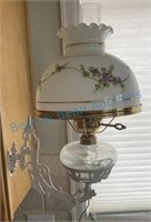 Antique kerosene lamp on cast-iron bracket has