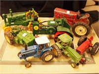 Seven toy tractors including die-cast and cast