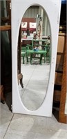 Mirror , oval,  in a door frame
