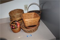 2 longaberger baskets and a pile of wicker baskets
