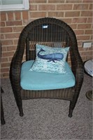2 wicker chairs, with cushions and throw pillows