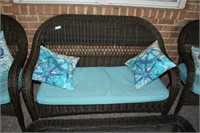 wicker love seat with cushions and throw pillows P