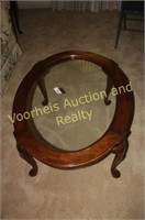 Oval wooden frame coffee table with glass top and