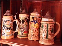 Four lidded beer steins: one is a music box,