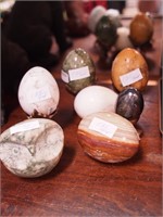 Group of alabaster items: eggs, carved