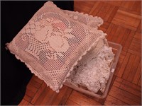 Container of vintage crocheted tablecloths,