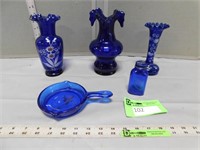 Blue glassware including bases, a bottle and a gla
