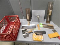 Trowels and sponges in a plastic crate
