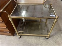 BRASS COLORED TEA TROLLEY WITH GLASS SHELVES
