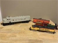 Diesel locomotive and assorted HO scale cars