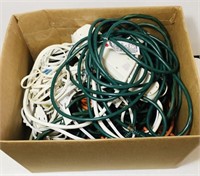 Box full of extension cords and 3 power strips