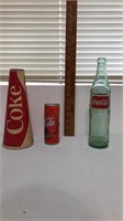 Coca Cola can with Coca Cola still inside empty.