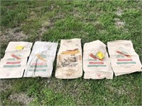 4-DeKalb seed corn bags and 1- farmer hybrid seed