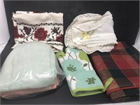 Assortment of linens, doilies and table cloths.