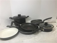 Collection of six frying pans, a pasta pot and
