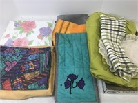 Assortment of tablecloths and linens.