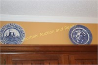 7 blue & wite plates above kitchen cabinets