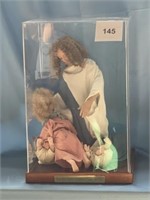 Porcelain Jesus and Babies in Showcase