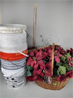 Artificial flowers in large basket and plastic
