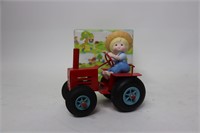 SCOOTER PORCELAIN FIGURINE ON METAL TRACTOR 5"