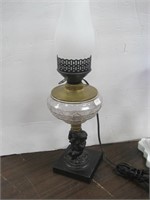 Figural metal oil lamp w/glass font