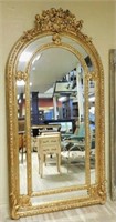 Grand Putti Crowned Gilt Framed Beveled Mirror.