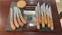 8 new place mats with two sets of knives - six