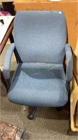 Light blue upholstered office chair with arms,