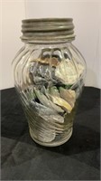 Decorative swirl glass jar with seashells with a