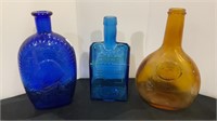 Lot of three colored glass bottles - old cabin