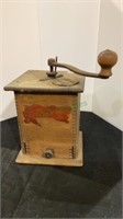 Antique coffee grinder with wooden handle. Stands