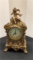 Victorian-style mantle clock with a cherub on