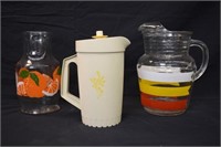 2 GLASS JUICE JUGS AND A TUPPERWARE PITCHER