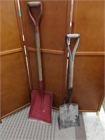 Two shovels with wooden handles.
