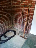 Contents of back porch- garden tools, hose