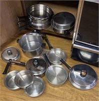 stainless pots and pans in cupboard - clean